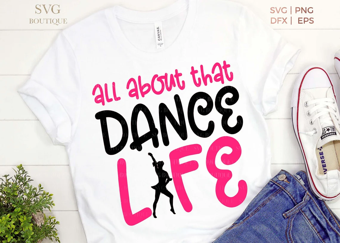 Dancing life is written on a t-shirt in pink.