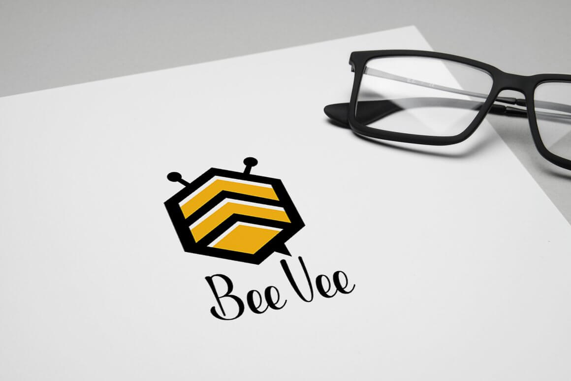 The Beevee logo is drawn on a white sheet of paper next to the sheet of glasses.