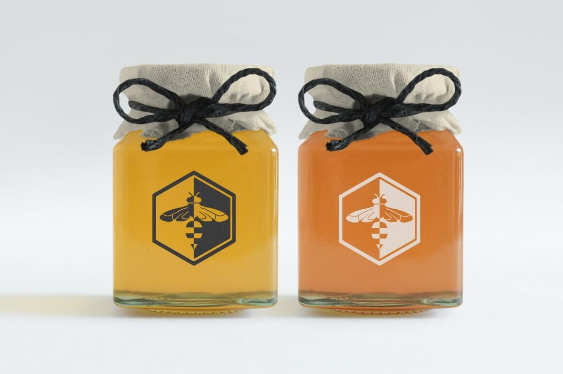 Jars with different types of honey and an image of the wasp logo in a large honeycomb.