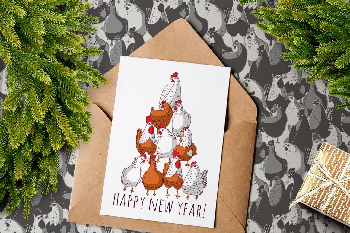 On a light beige envelope lies a white postcard with a picture of chickens and the inscription Happy New Year.