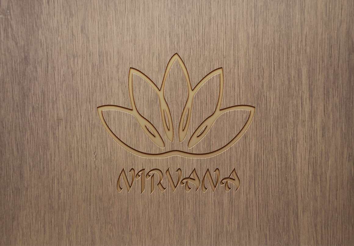 Lotus logo and the inscription Nirvana on a wooden background.