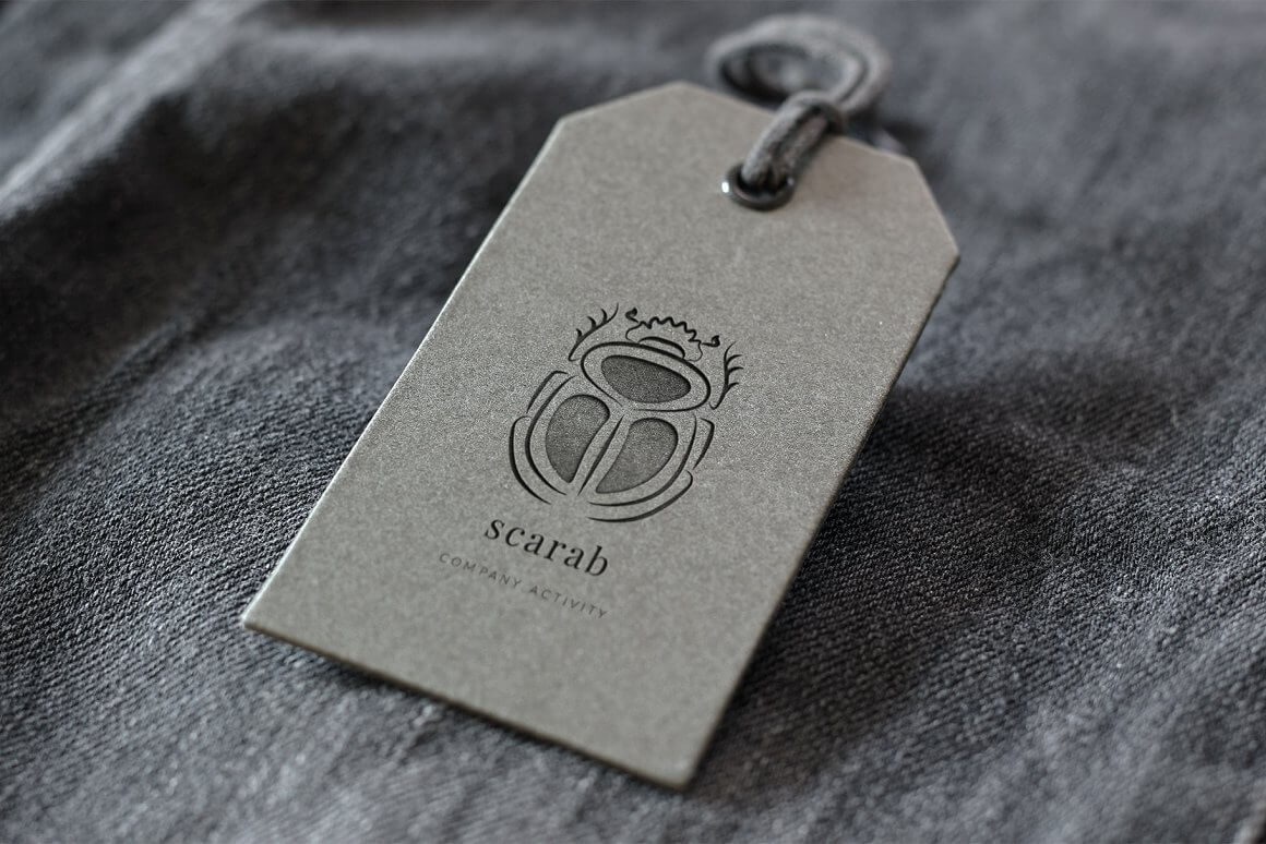 Logo with a design image of a scarab with a dark gray body on the tag.