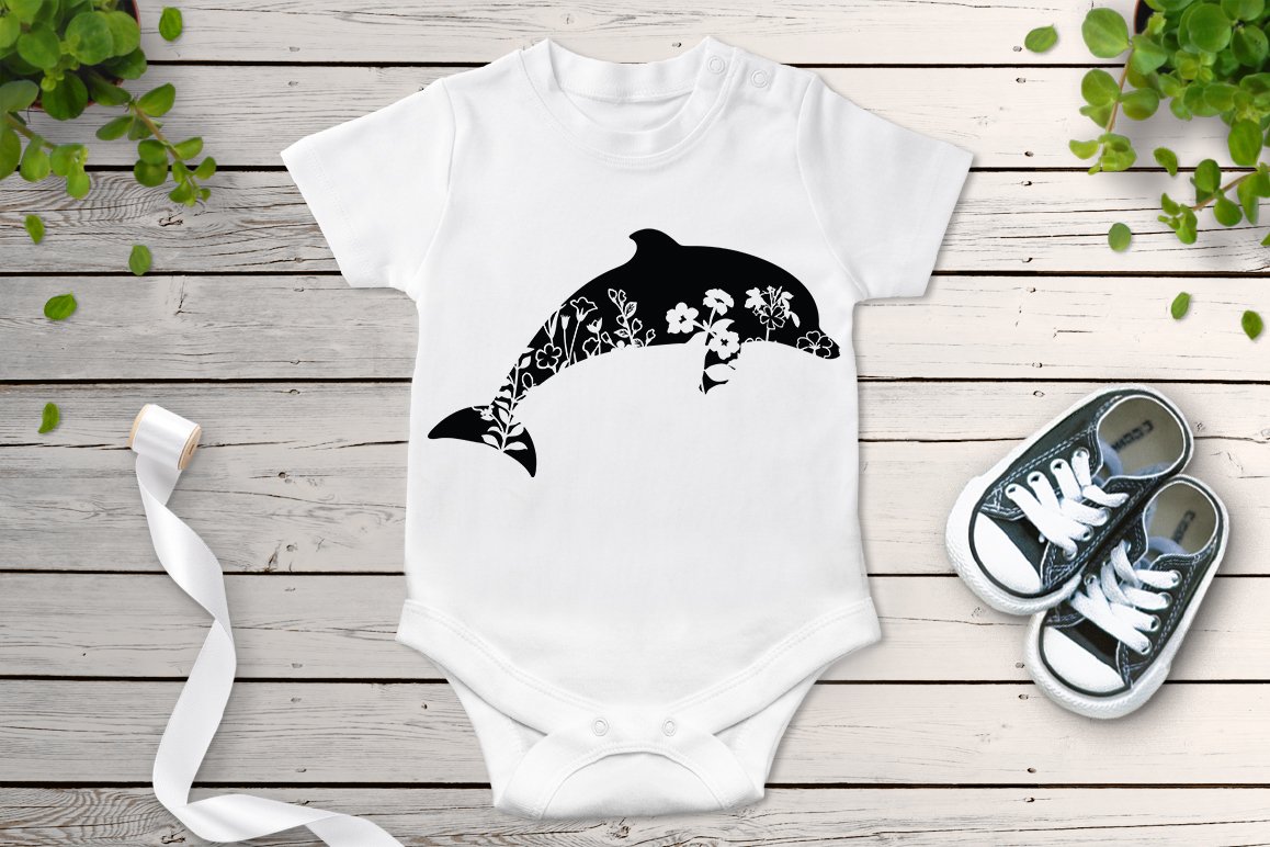 Baby bodysuit with a dolphin and skulls on it.