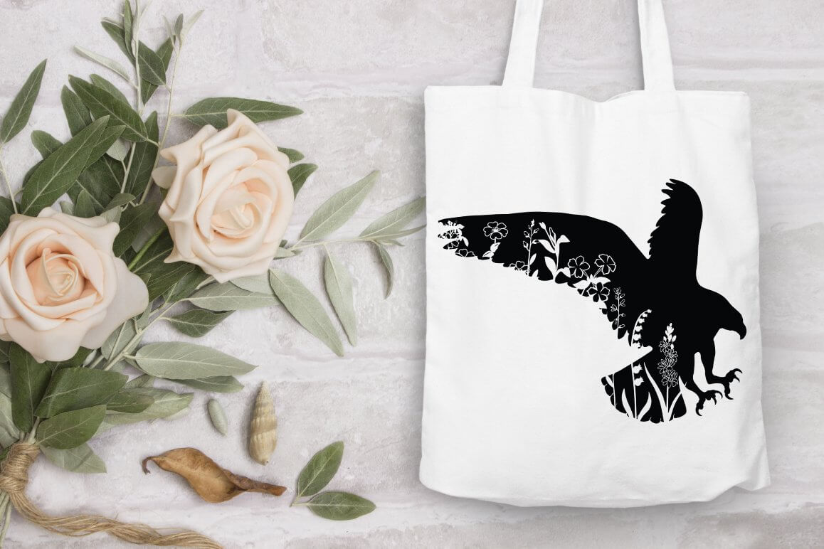 A floral eagle is drawn on a white bag.