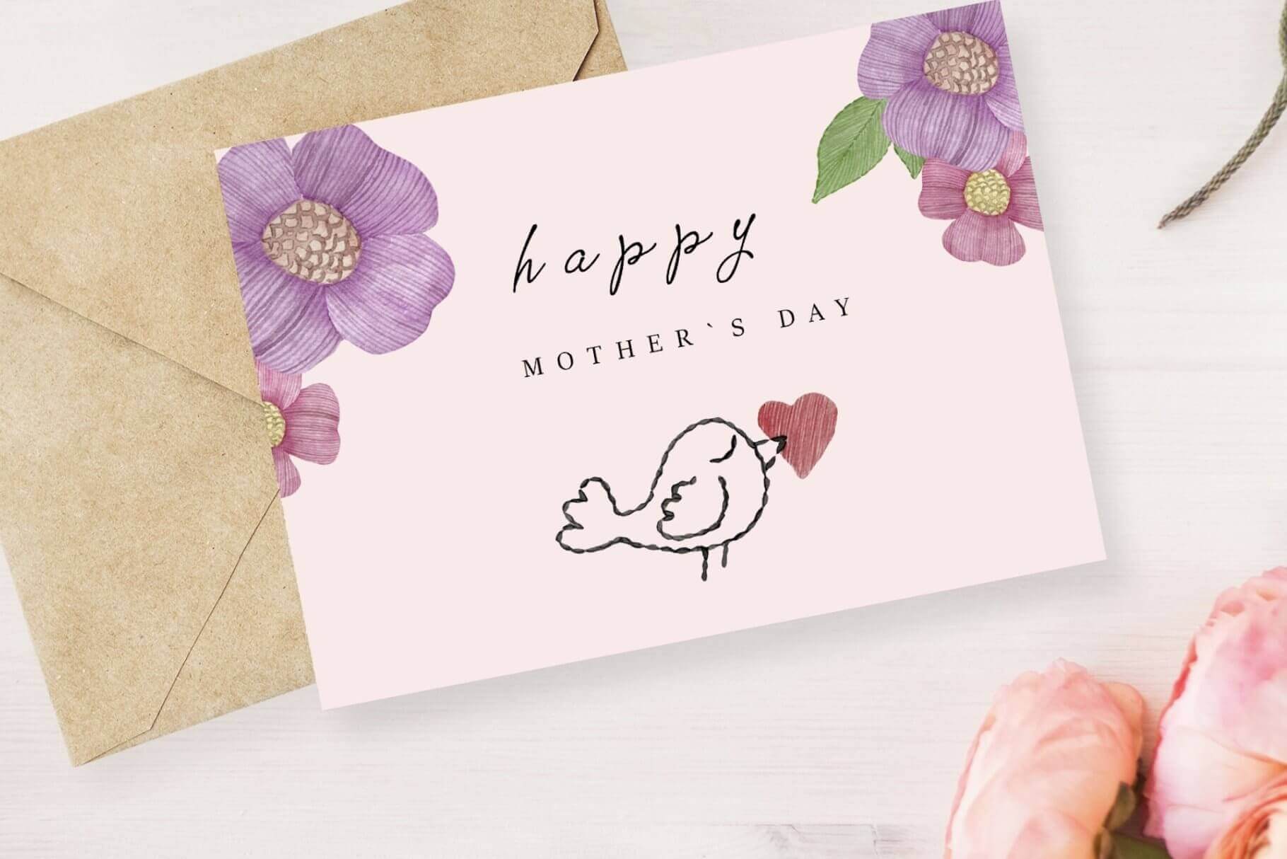 Pale pink card on which an embroidered bird and flowers are drawn with the inscription Happy Mother's Day.