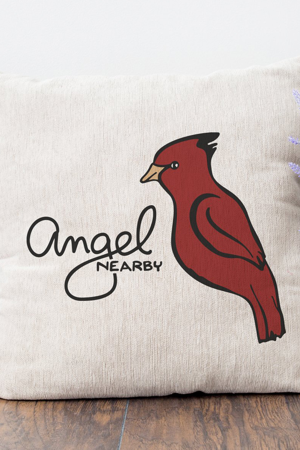 Pillow with a red bird on it.