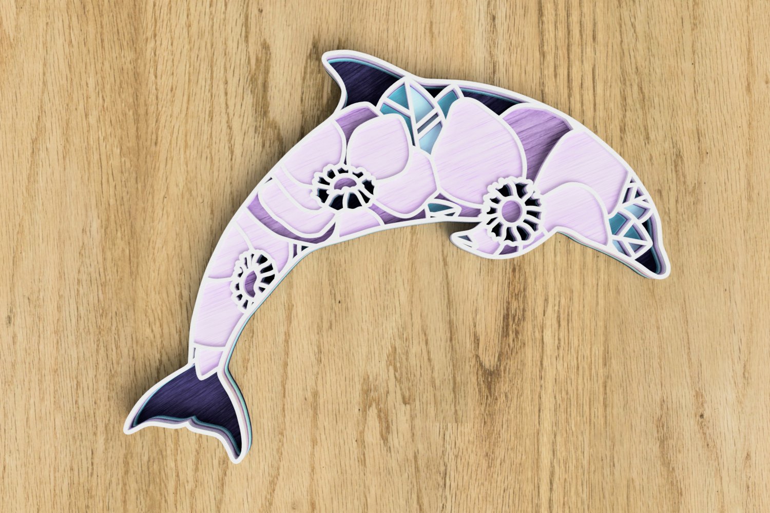 Paper cut of a dolphin on a wooden surface.