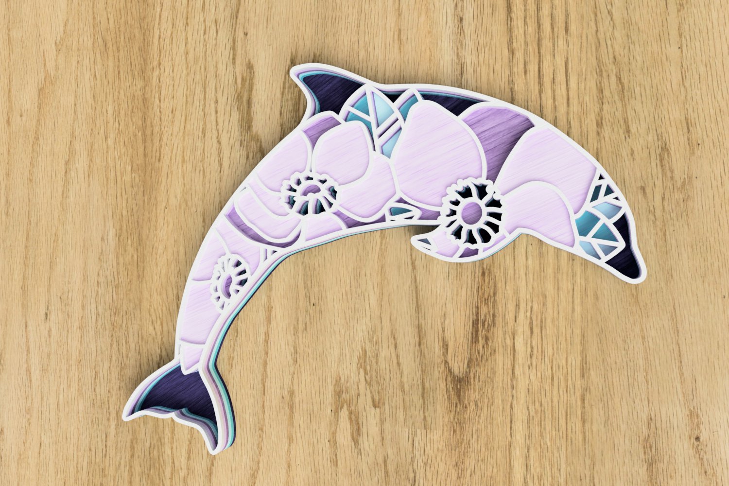 Paper cut out of a dolphin on a wooden surface.