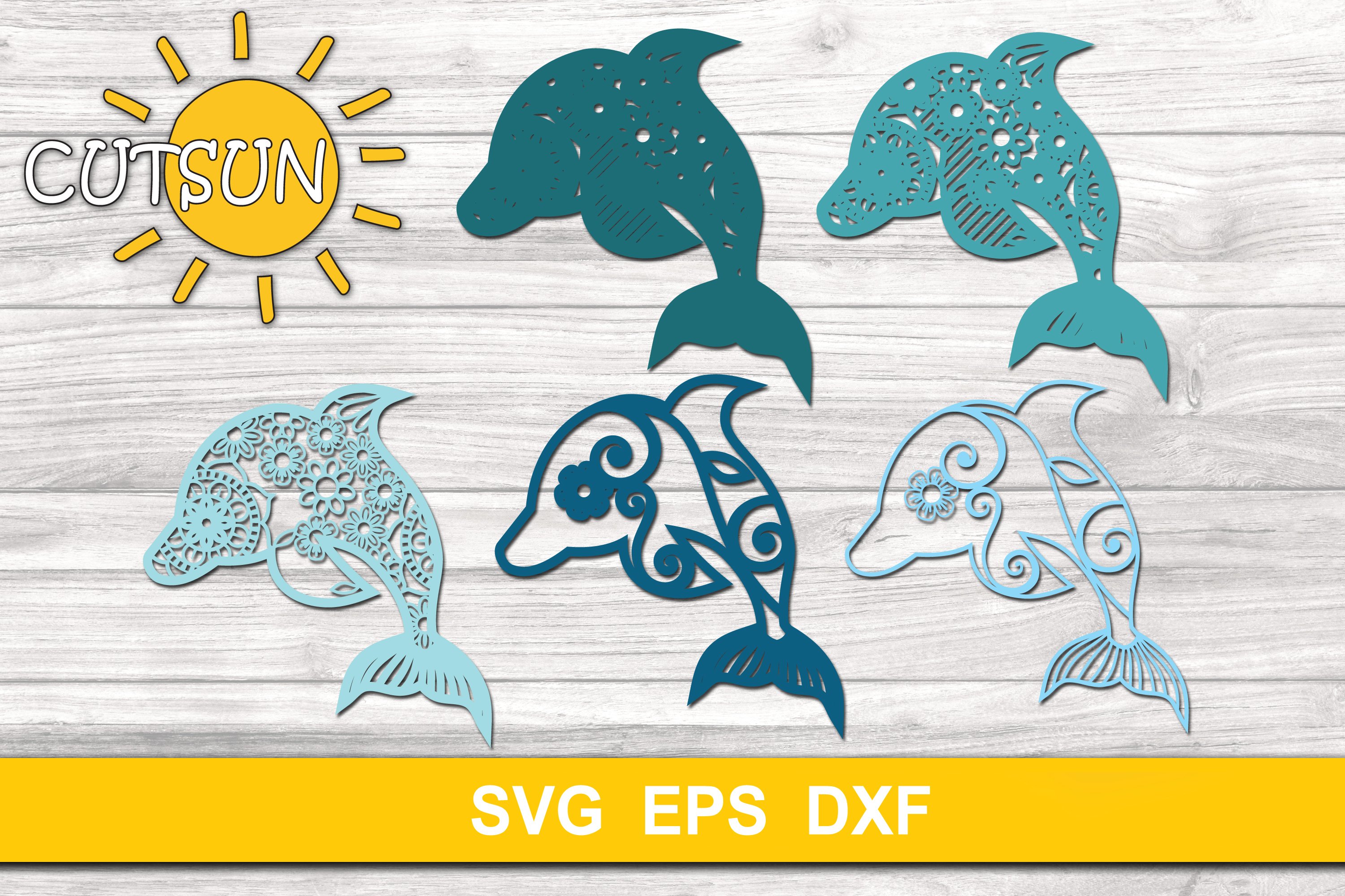 Set of cut outs of dolphins on a wooden background.