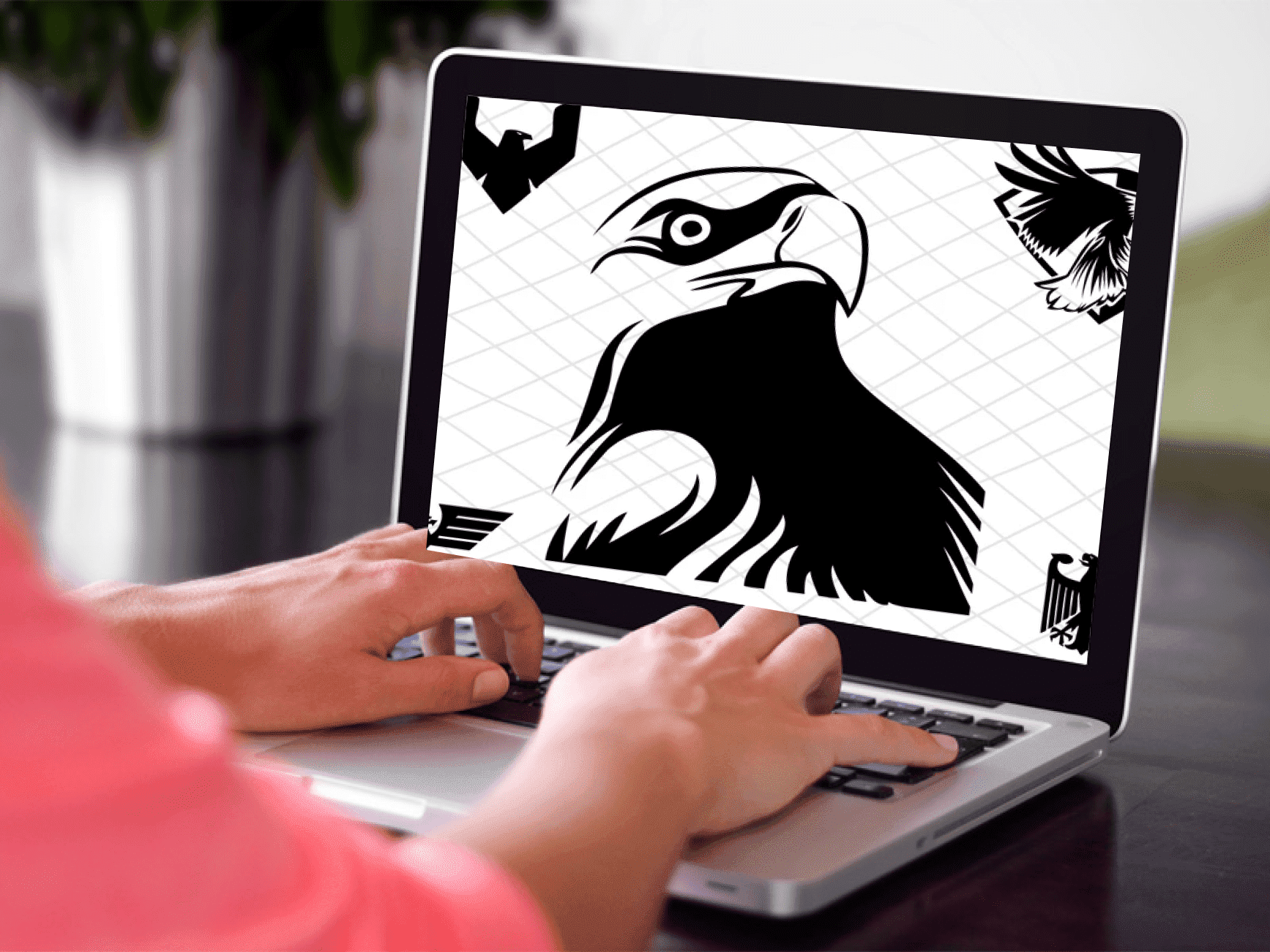 Woman using a laptop computer with a picture of an eagle on the screen.