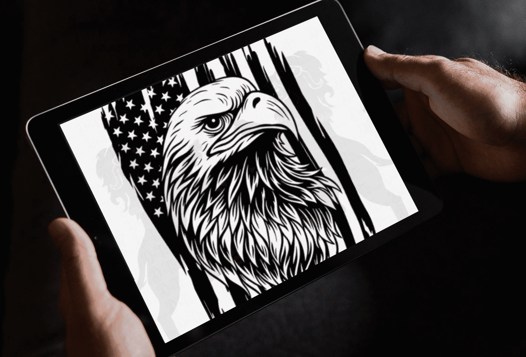 Person holding a tablet with an eagle on it.