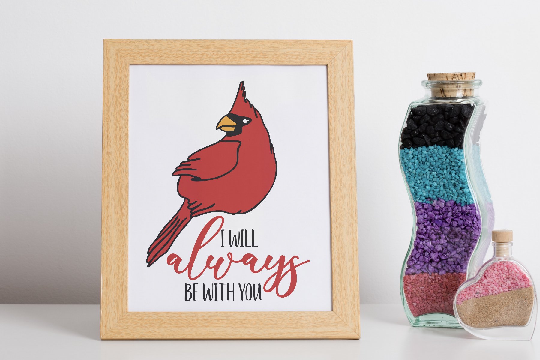 Picture of a cardinal on a wall next to a bottle of beads.