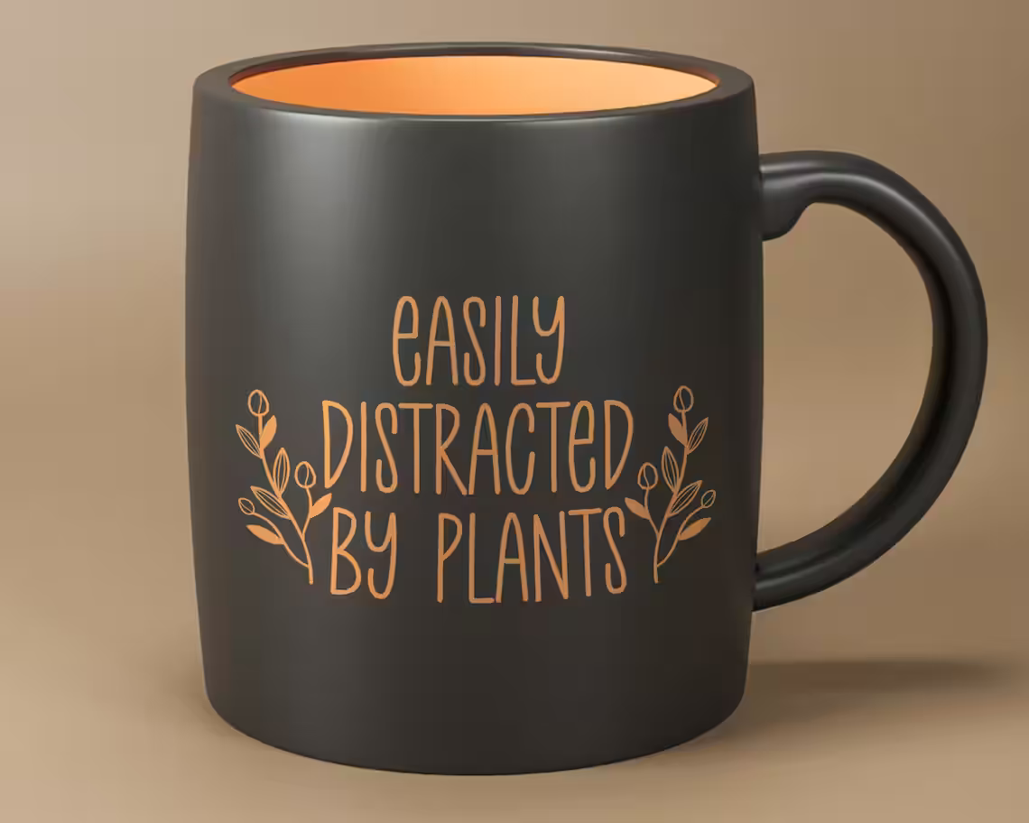 Print on black cup with orange center and lettering on the outside.