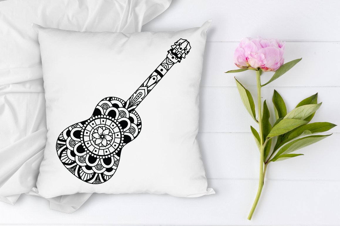 Guitar print with patterns on the pillow.