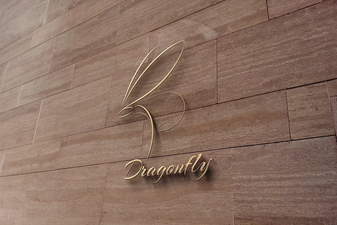 Golden dragonfly logo on a brown tiled wall.