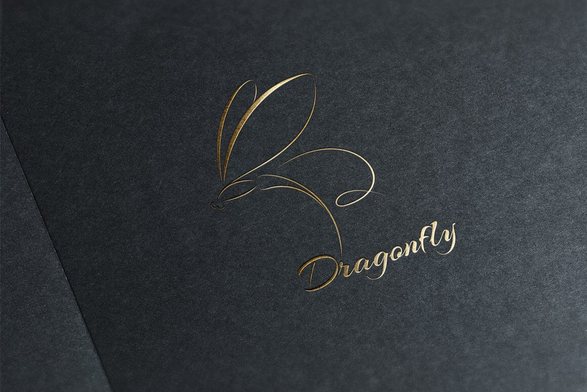 Golden dragonfly logo on a black textured background at an angle.