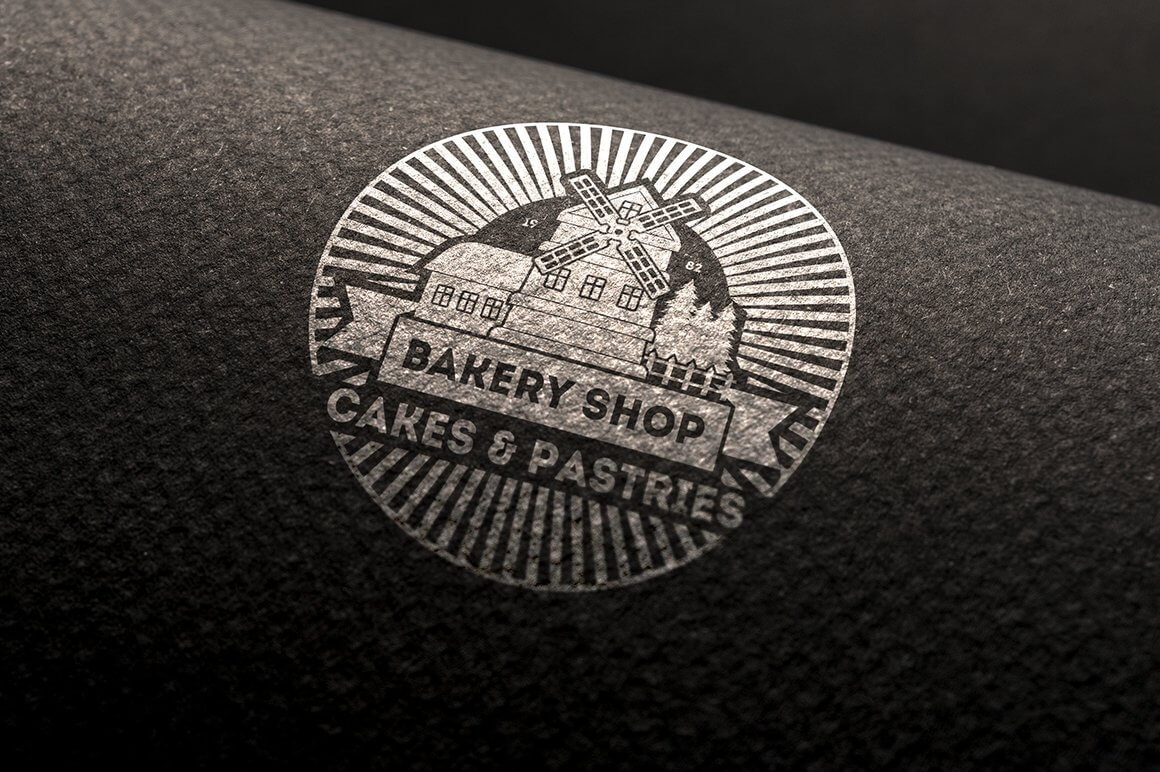 Large round white "Bakery Shop, Cakes & Pastries" logo on black fabric.