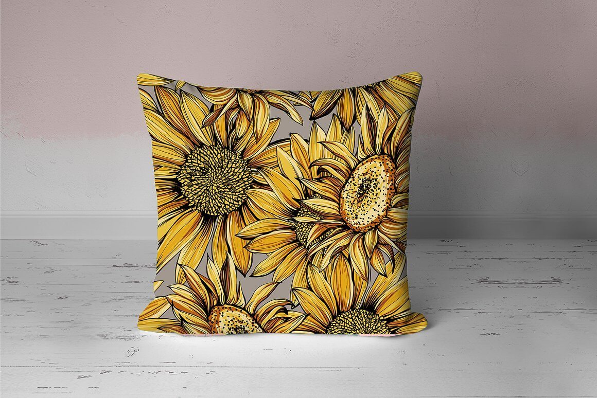 Yellow and black sunflowers are depicted on a small pillow.