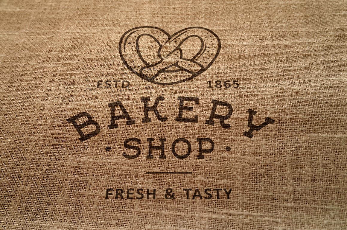Brown bakery logo "Bakery Shop, fresh & tasty" on burlap.