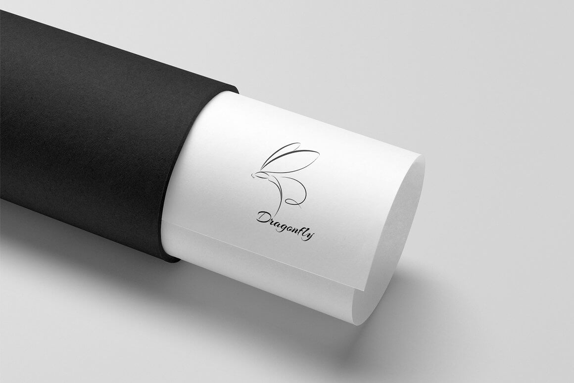 Black dragonfly logo on a white sheet in a tube.