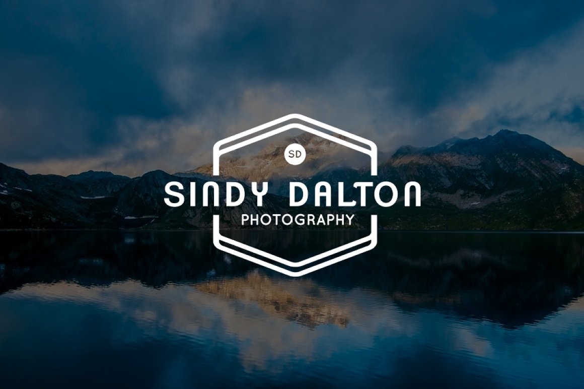 Logo with a landscape of a lake and mountains.