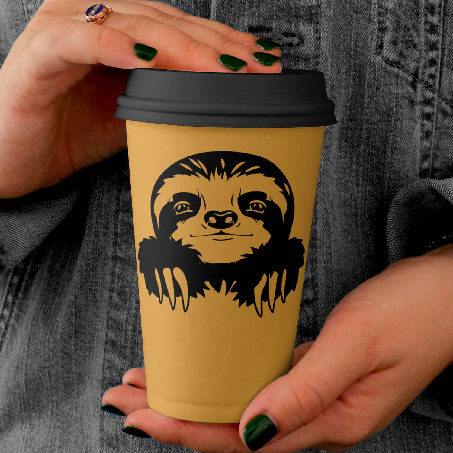 Woman holding a coffee cup with a slot face on it.