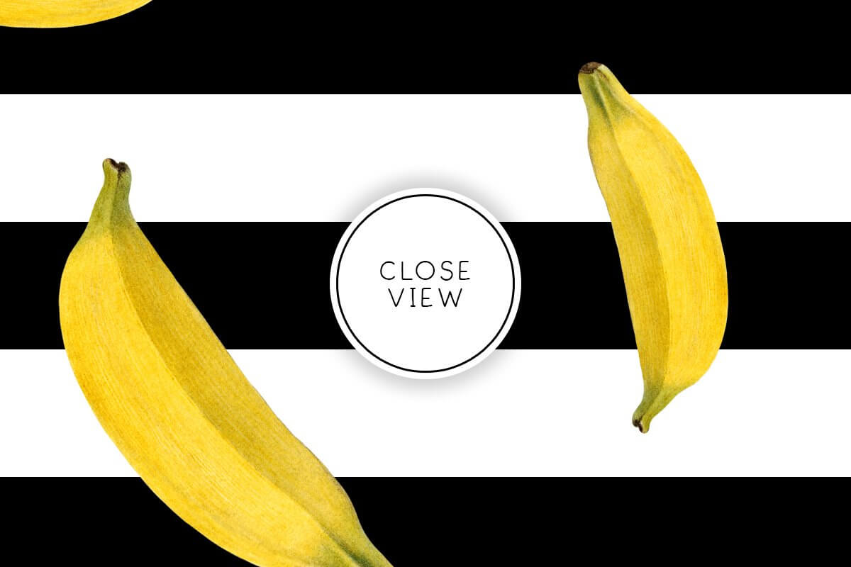 Large yellow bananas on a white and black striped background.