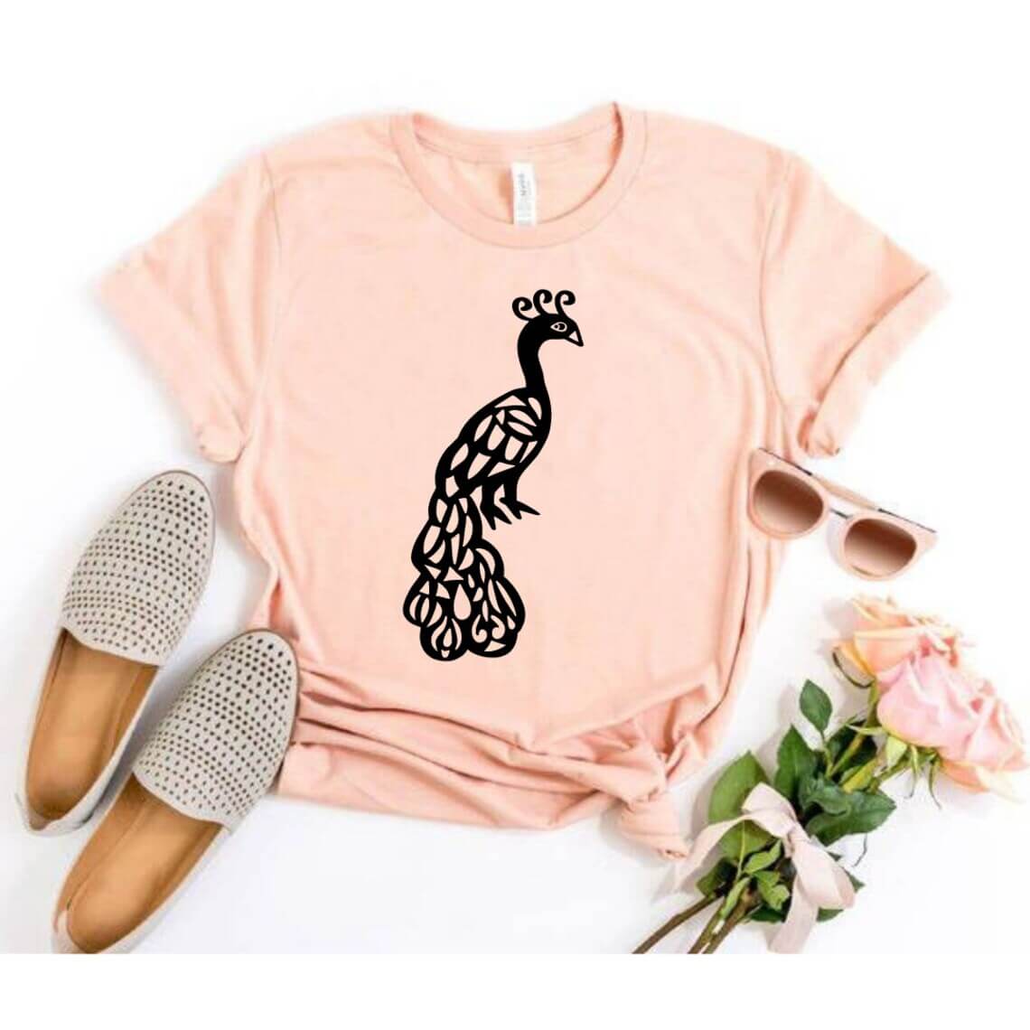 Pink shirt with a black peacock on it.