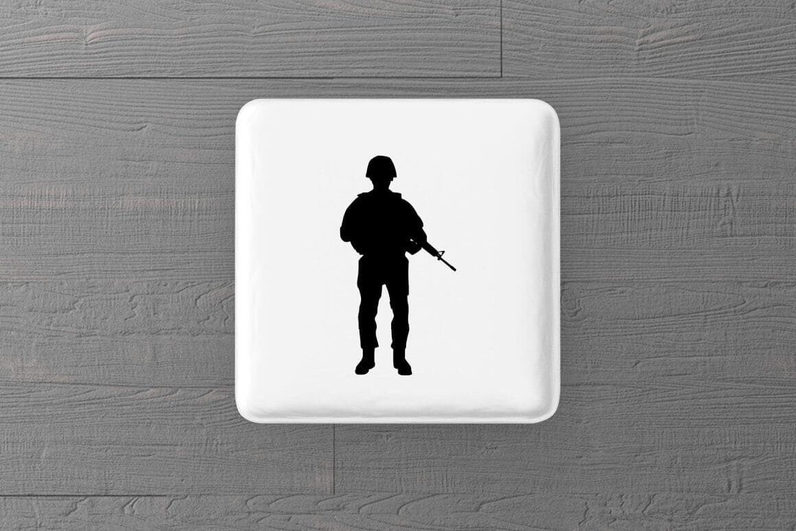 The silhouette of a soldier on duty in military uniform is on the white button.