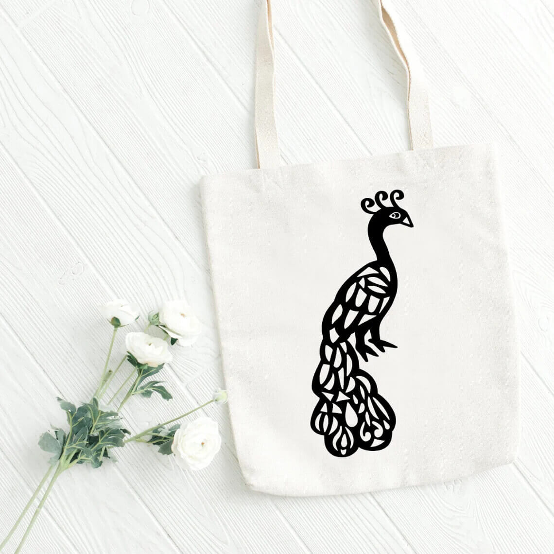 Tote bag with a black and white peacock on it.