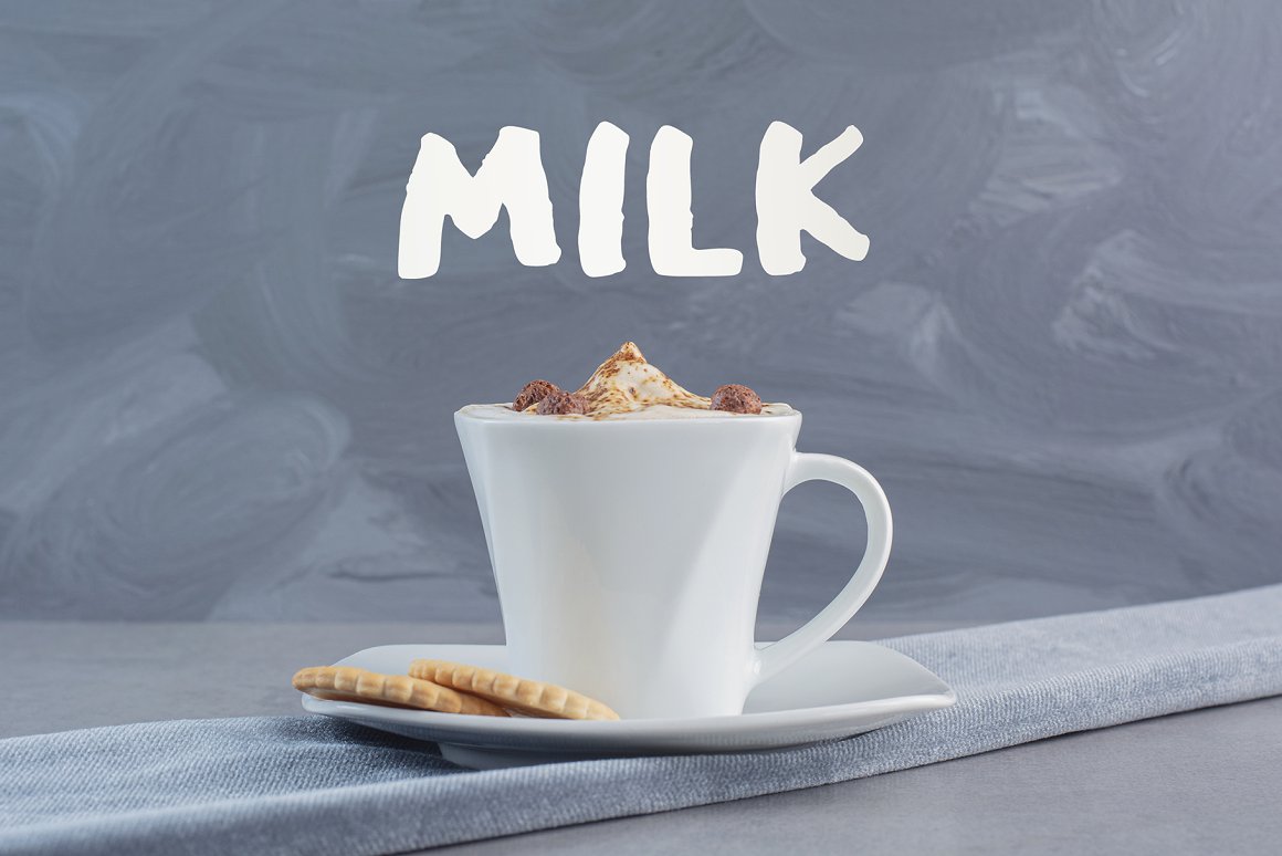 Milk, a cup of coffee on a gray background.