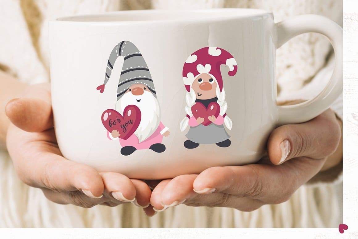 A girl is holding a large white mug with Valentine's gnomes in pink flowers.
