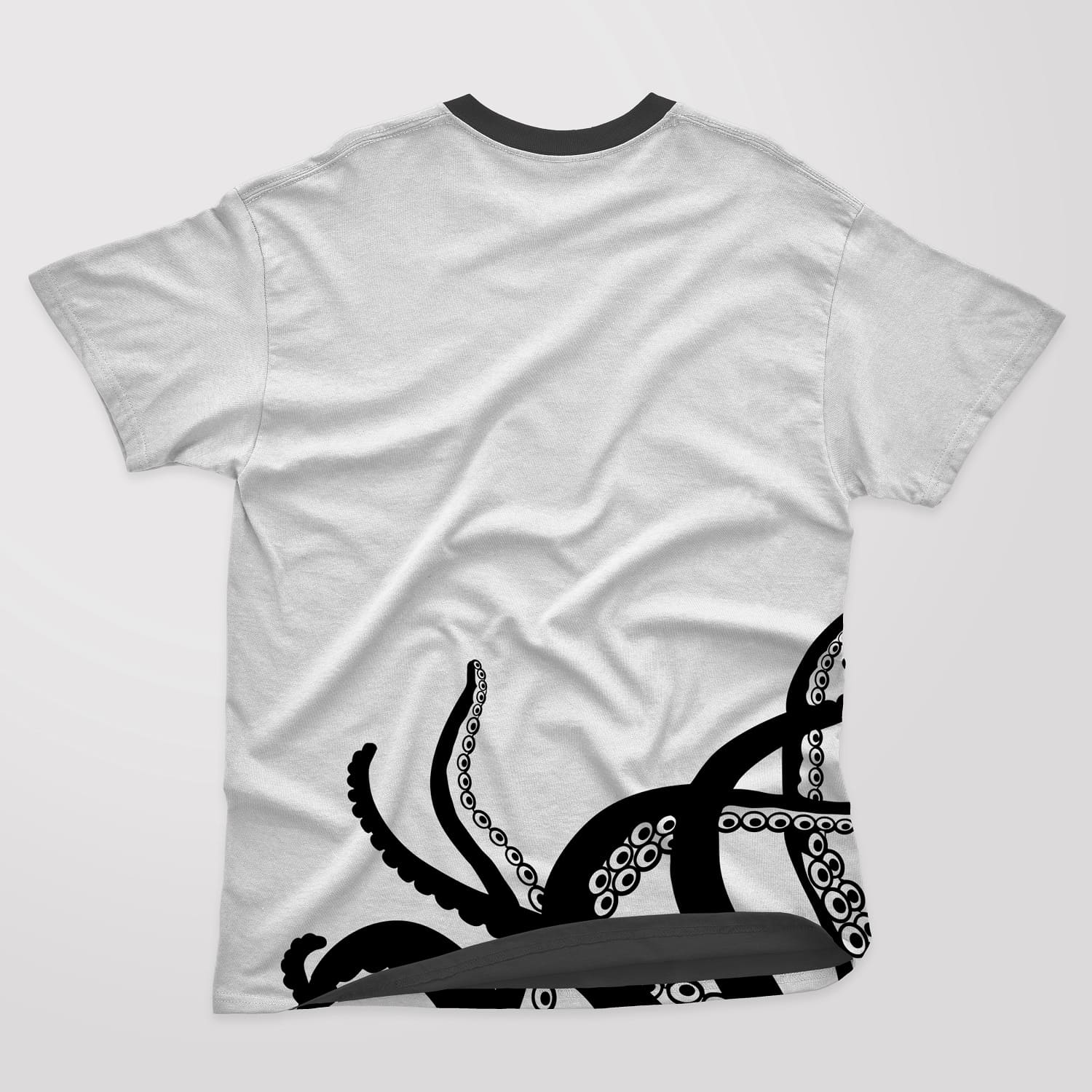 Black and white t-shirt with six octopus tentacles on a white background.