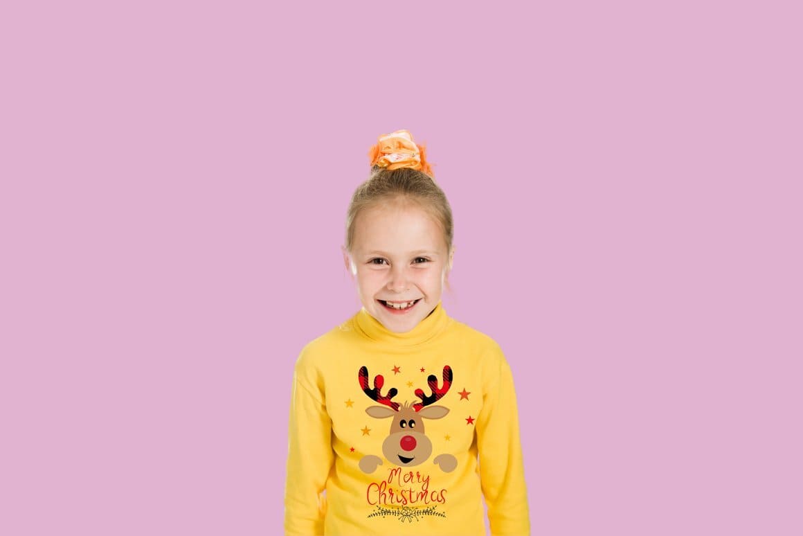 Image of a girl in a yellow sweater with a Christmas deer drawn on it.