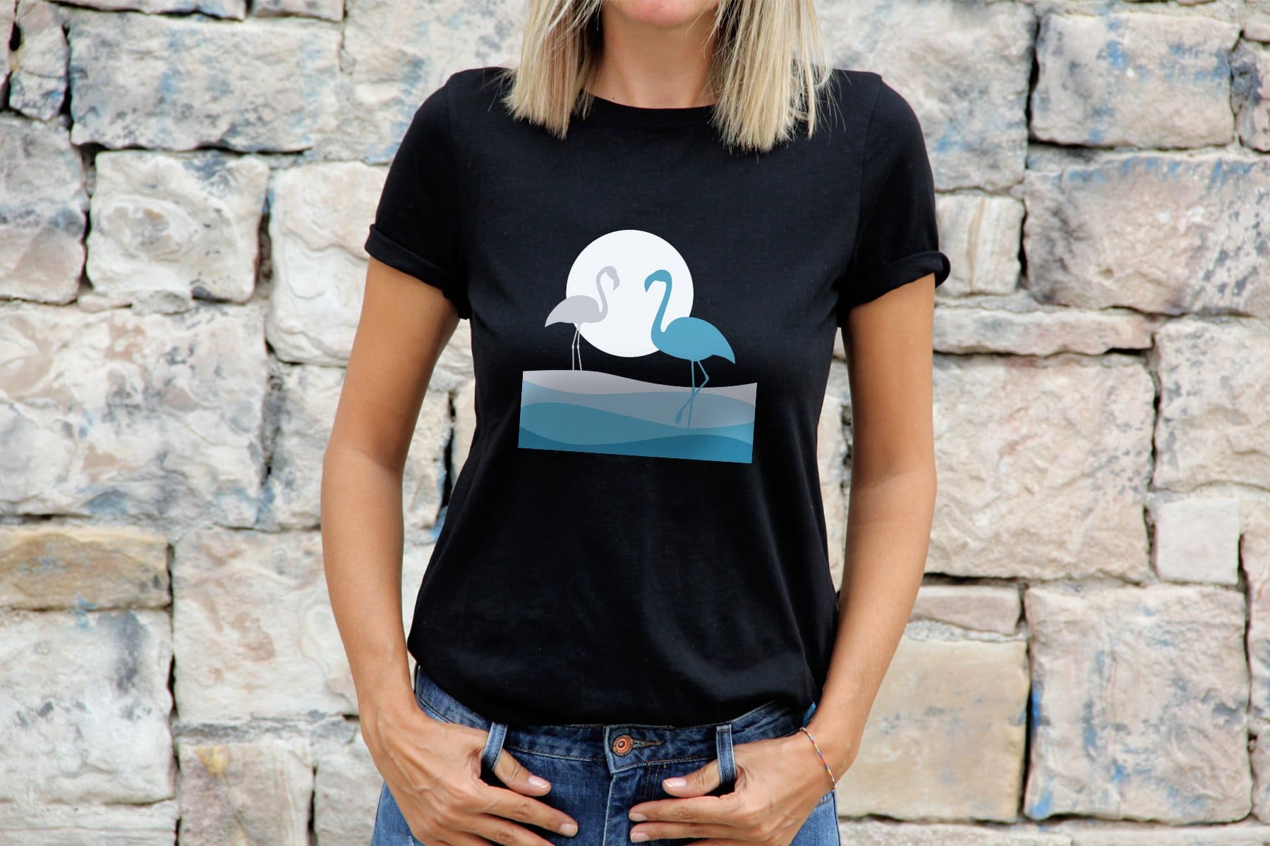 The black t-shirt features flamingos in white and blue.