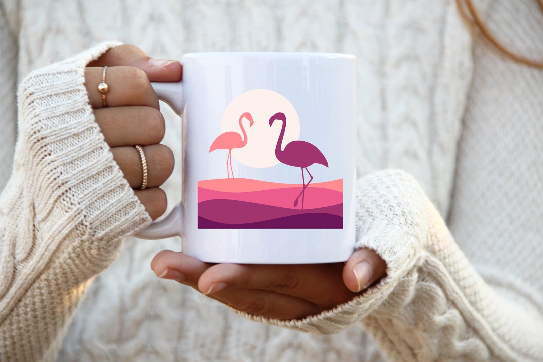 Pink flamingos are depicted on the white cup.