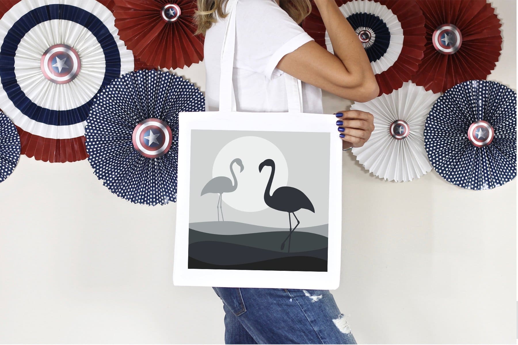 Gray and black flamingos are depicted on the white bag.
