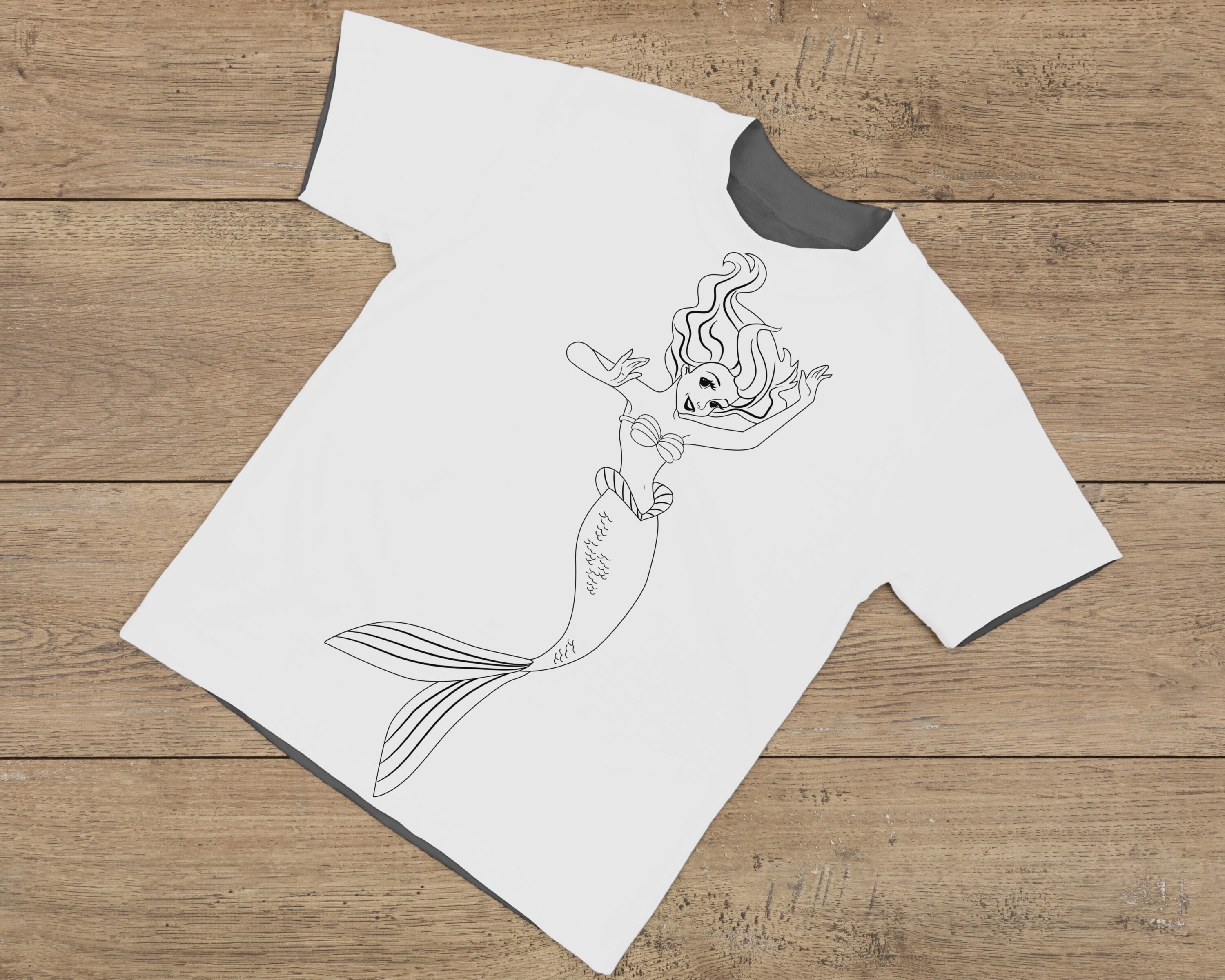 Havre print of mermaids on a T-shirt of a girl in jeans.