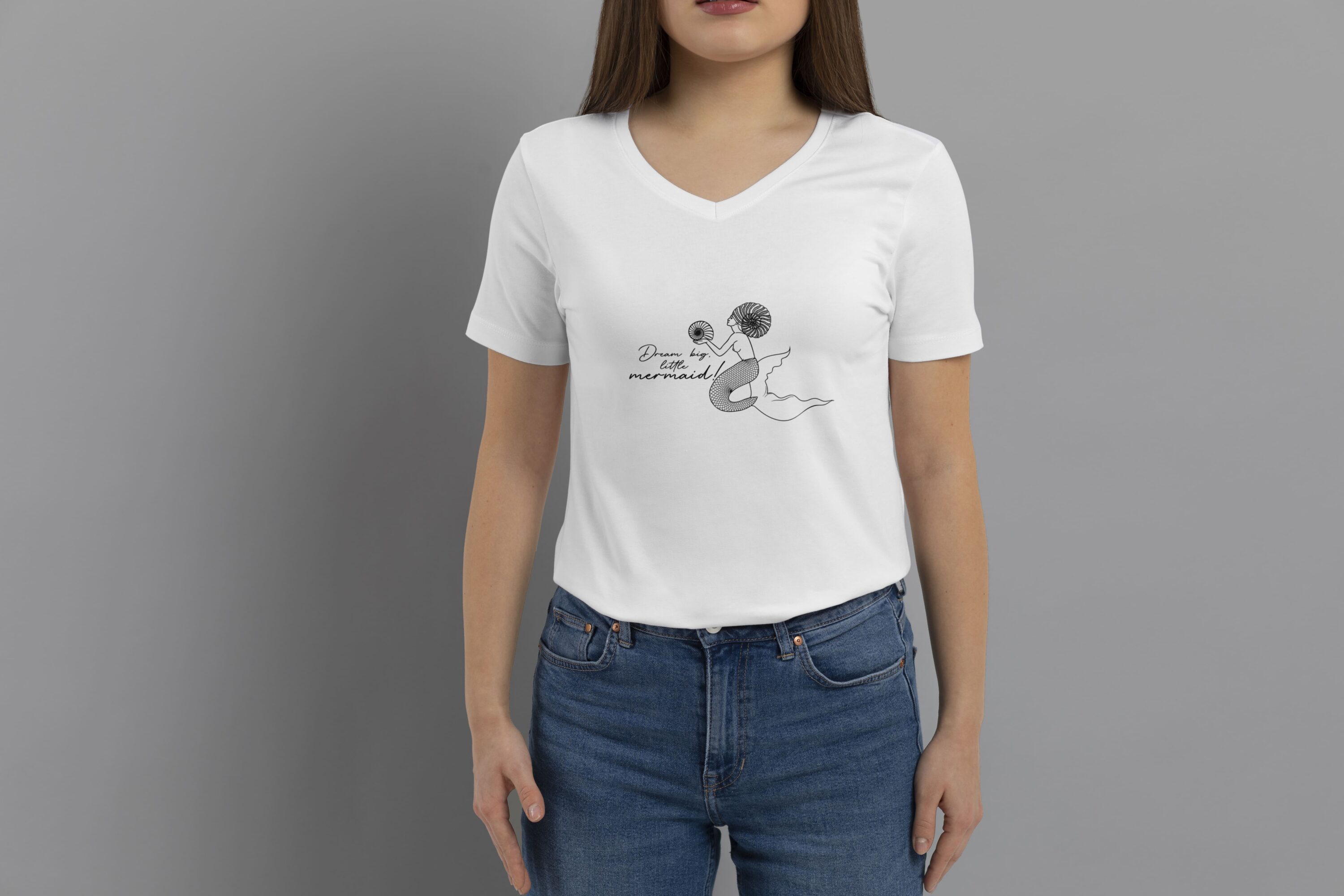 Havre print of mermaids on a T-shirt of a girl in jeans.