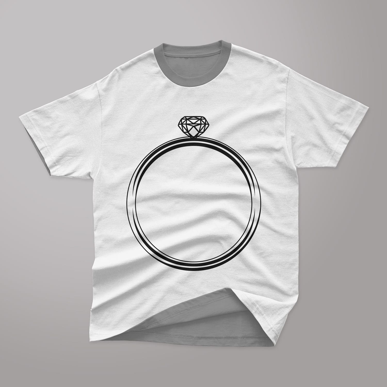 A wedding ring with a diamond drawn on a light gray t-shirt.