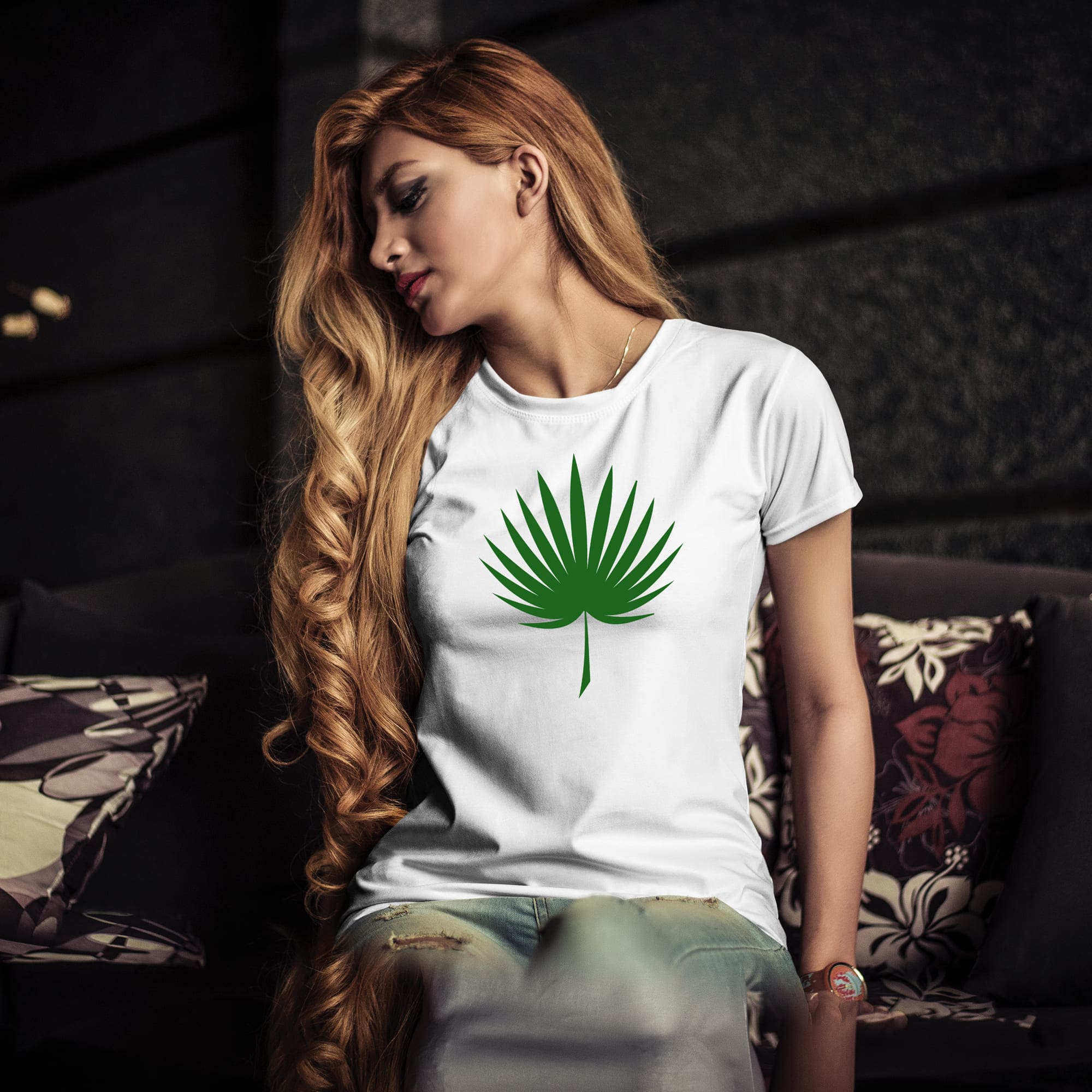 Large palm leaf painted on a woman's white t-shirt.