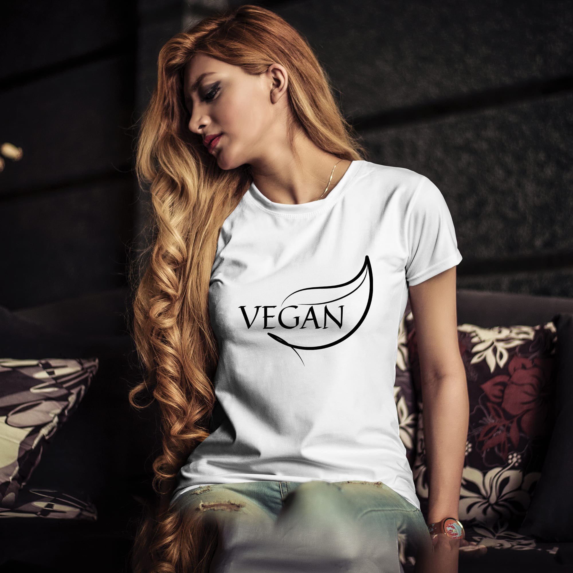 The word vegan is painted on a girl's T-shirt.