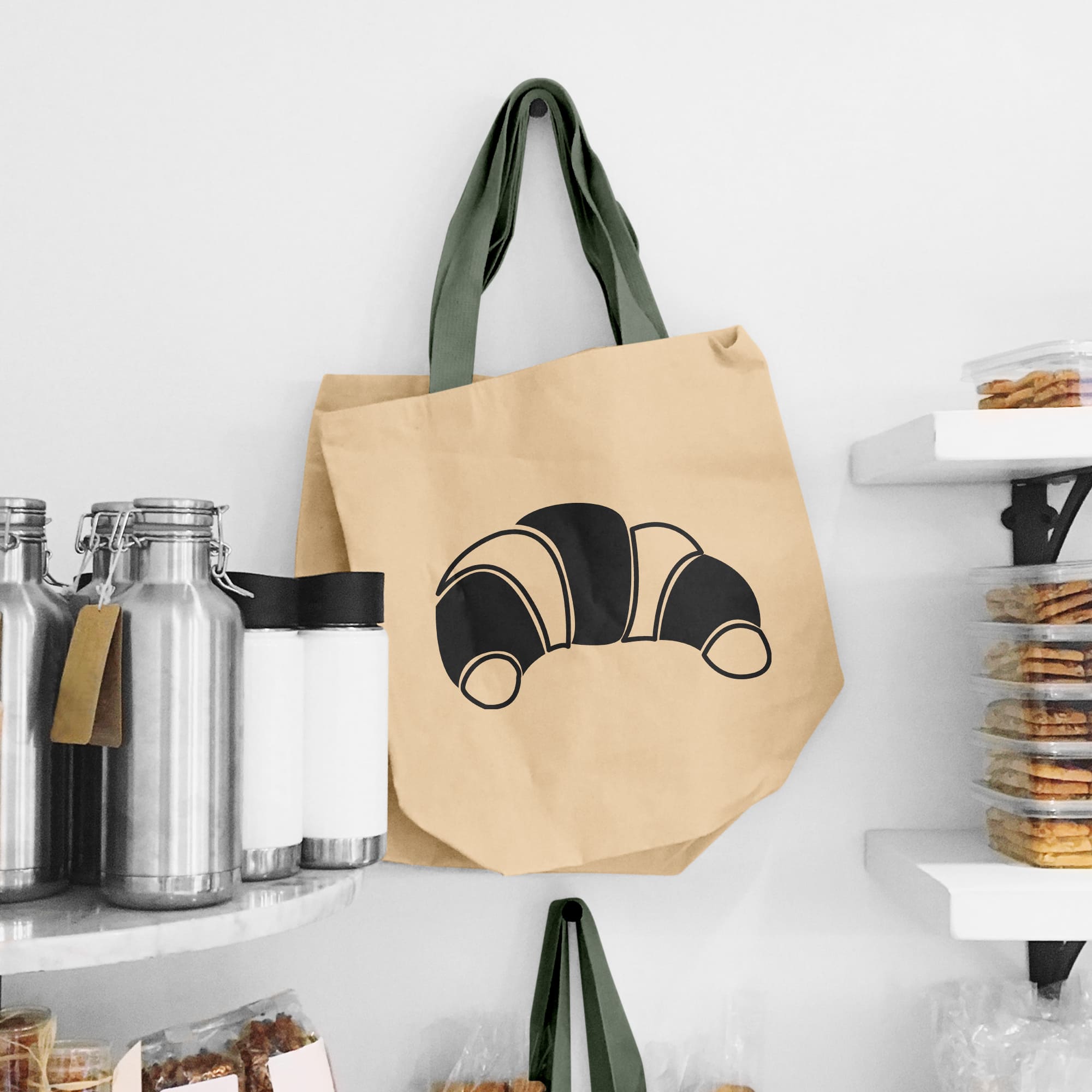 A croissant is drawn on a beige bag.