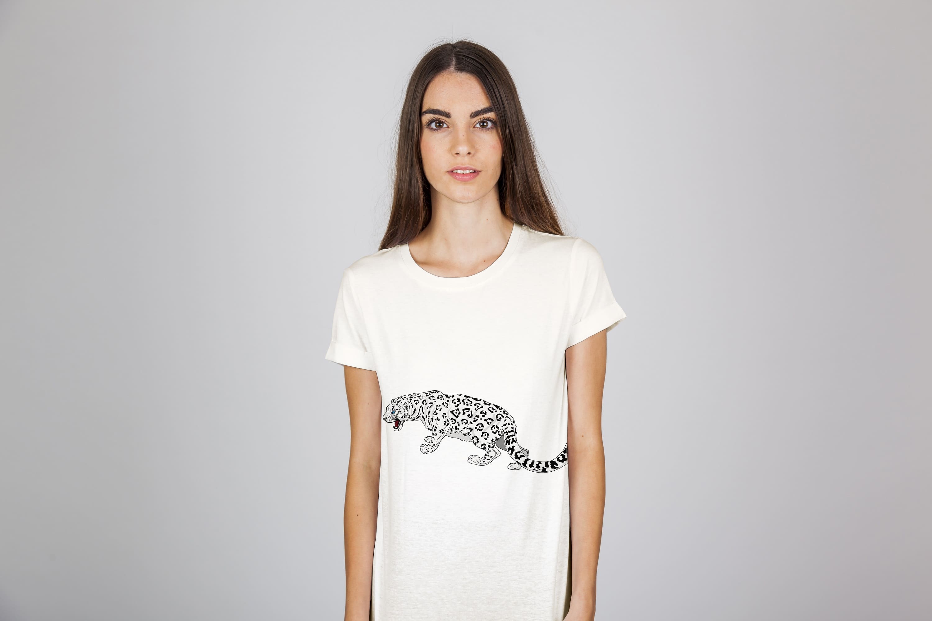 A snow leopard in a fighting pose on a white t-shirt.