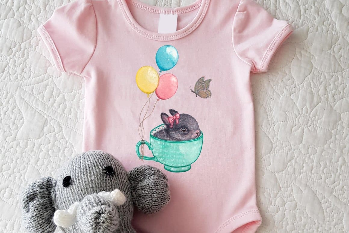 Children's pink bodysuit with a small Easter bunny in a green cup.