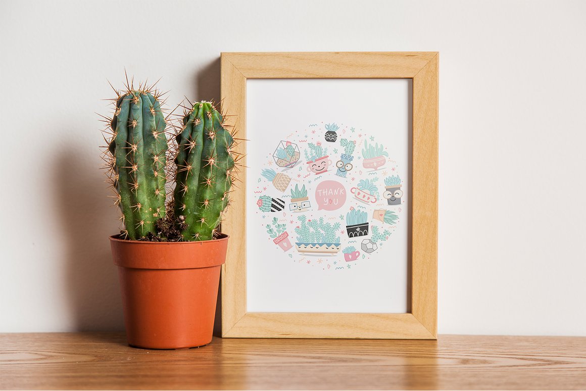 A cactus in a pot and a picture.