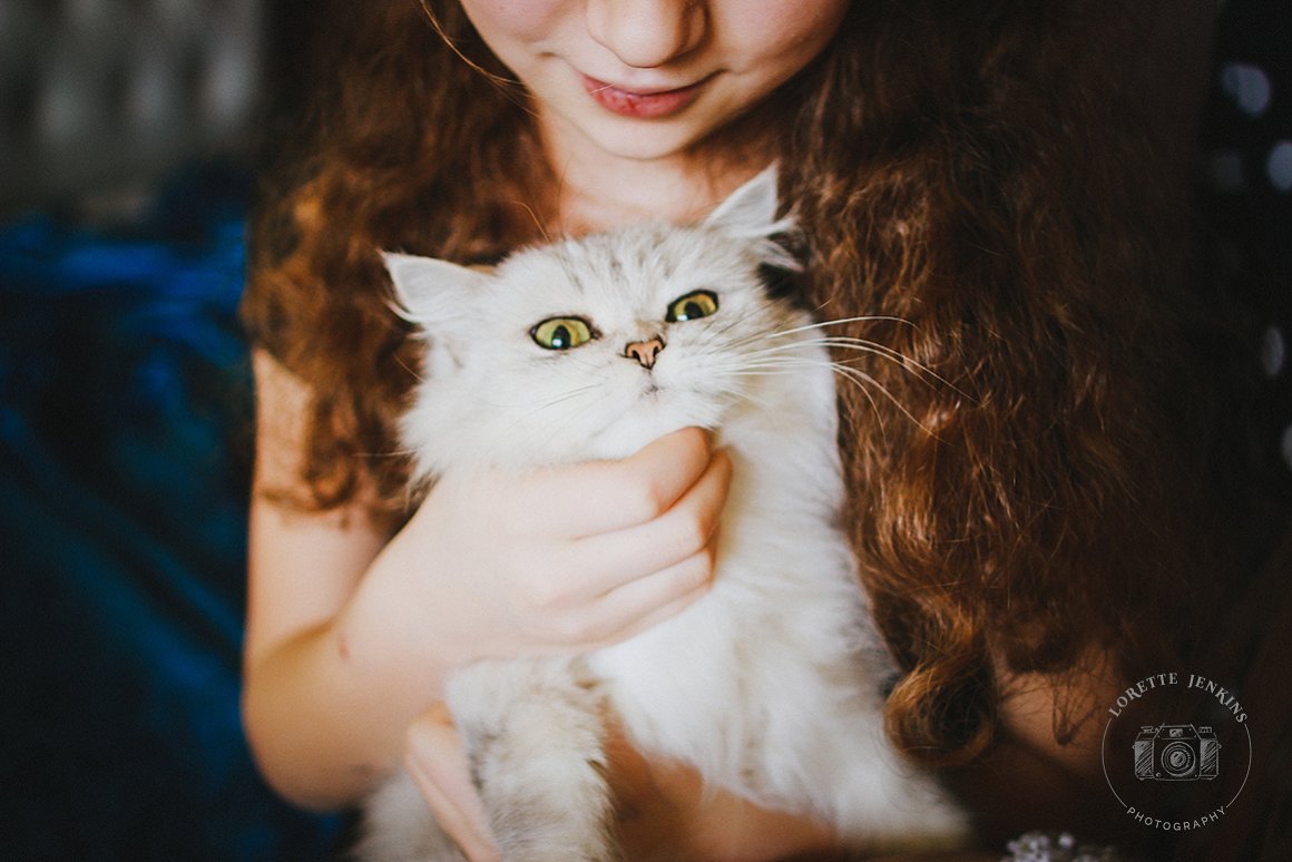 A girl with a white cat.