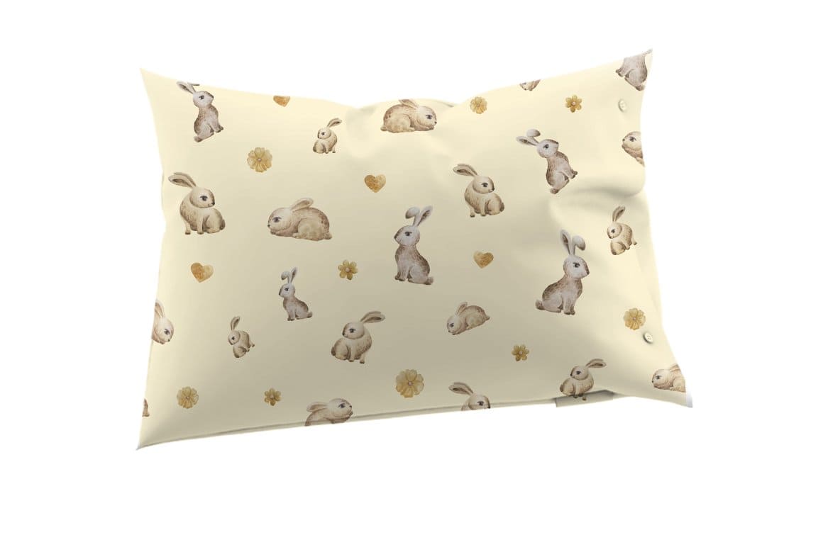 Fuzzy rabbits with long ears are drawn on the pillow.