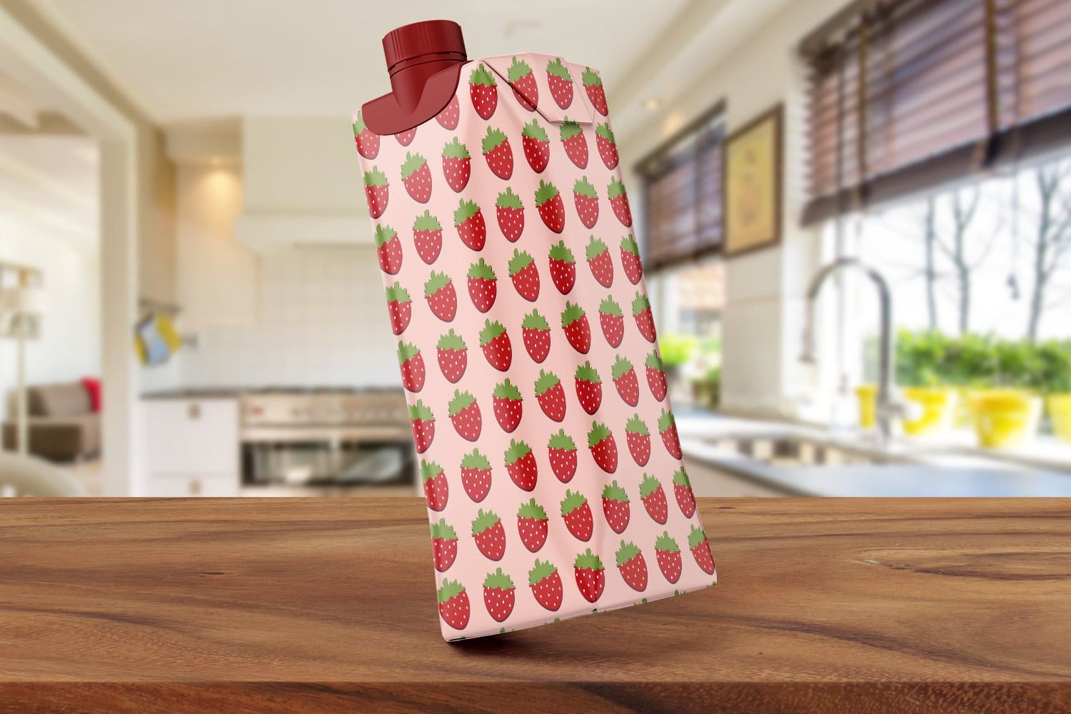 A packet of milk with a strawberry print.