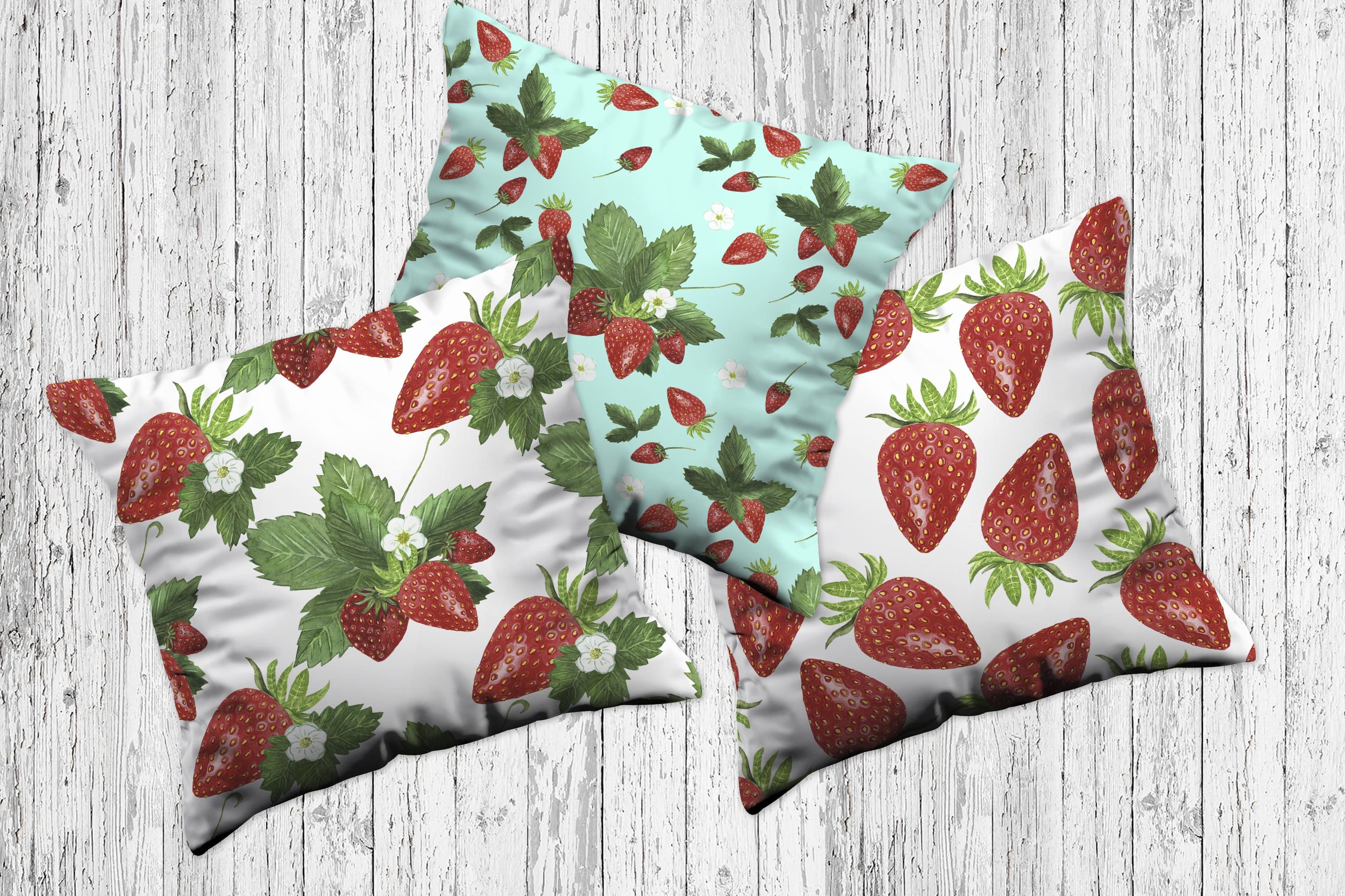 Three pillows with a strawberry design.
